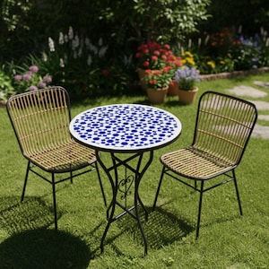 May include: A garden bistro set comprising a round table and two chairs. The table features a white surface adorned with a blue geometric design. The chairs have woven backs and seats. The set is constructed from black metal and is placed on a grassy lawn.