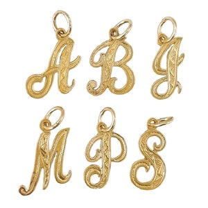 May include: Six gold-tone cursive letter charms with a decorative etched pattern. The letters are A, B, J, M, P, and S.