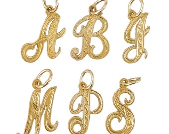 May include: Six gold-tone cursive letter charms with a decorative etched pattern. The letters are A, B, J, M, P, and S.