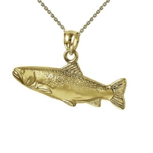 May include: A gold-colored fish pendant necklace. The fish is detailed with scales and fins. The chain is a delicate, thin chain.