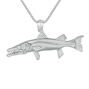 May include: A silver barracuda fish pendant necklace. The pendant is detailed with a realistic depiction of the fish, including its sharp teeth and fins.