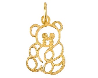 May include: A gold-coloured pendant charm in the shape of a cartoon bear. The bear is sitting with its paws in front of it.