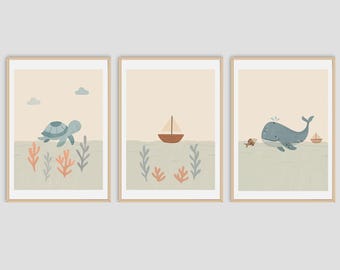 May include: A set of three framed art prints depicting ocean scenes. One print shows a turtle, another a sailboat, and the third a whale. Each print has a beige background with sea life illustrations.