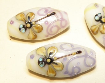 One (1) Ivory Flat Oval Lampwork Focal Bead with Tan Dragonfly and Purple Scroll Design - Lot UU