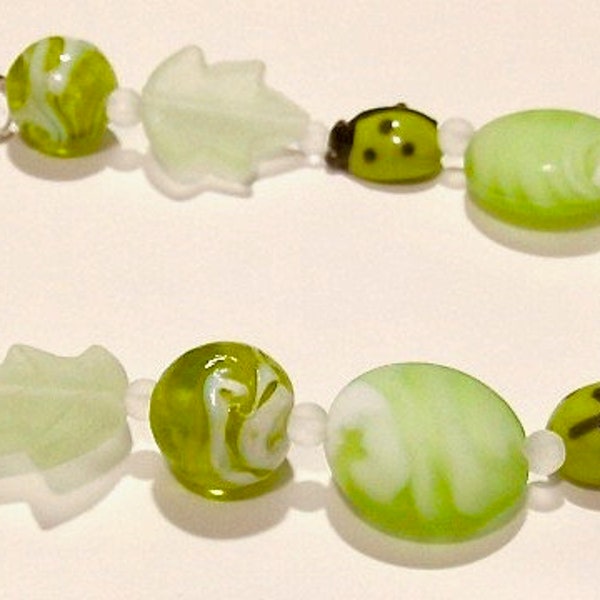 One (1) 7.5" Strand Coordinating Peridot Green Glass Beads: Ladybugs and Leaves --- Lot 5H