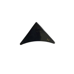 May include: Black triangle-shaped hair clip with a gold letter 'Z' on the side.
