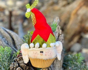 Digital sewing pattern:  Elf Cupcake ornament #213, Elf sitting in a regular cupcake paper, pointed hat with jingle bell and pompom fringe.