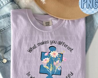 May include: A light purple t-shirt with the text "What makes you different is what makes you beautiful" and a blue puzzle piece with flowers inside.