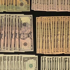 May include: A collection of prop money bills arranged in stacks, including denominations of one, two, five, ten, twenty, and fifty dollars. Each bill features the text 'FOR MOTION PICTURE USE ONLY' and 'PICTURE USE' printed clearly on the surface.
