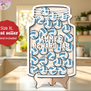 May include: A wooden reward jar in the shape of a mason jar, filled with blue and white volleyballs. The jar has the text "Tammy's Reward Jar" and sits on a wooden stand. The image also includes a red tag that says "Size XL" and "Best seller".