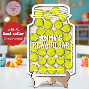 May include: A wooden reward jar shaped like a glass jar, filled with tennis balls. The text "AMMY'S REWARD JAR" is displayed in the center. The jar is on a wooden stand. The image also includes a red circle with the text "Size XL Best seller Stand included".