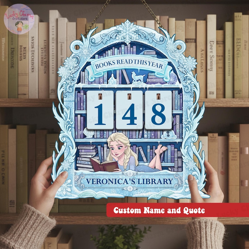 May include: A light blue wooden sign with a bookshelf design, featuring the text "BOOKS READ THIS YEAR" and the number "148". The sign includes an illustration of a woman reading and the text "VERONICA'S LIBRARY".