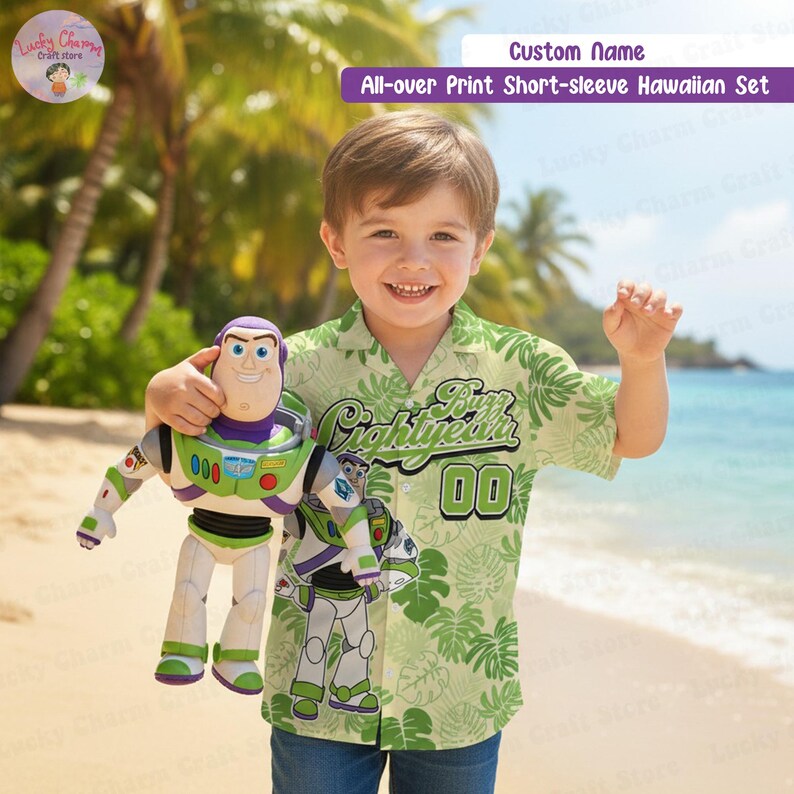 May include: A child in a green and white Hawaiian shirt featuring a Buzz Lightyear design, holding a Buzz Lightyear toy. The shirt has the text "Buzz Lightyear" and the number "00". The background shows a beach scene.