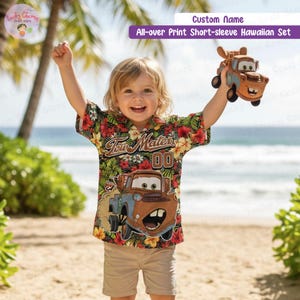 May include: A child's short-sleeved Hawaiian shirt featuring a floral pattern and a Tow Mater design. The child is wearing khaki shorts and holding a Tow Mater toy. The shirt has the text "Tow Mater 00".
