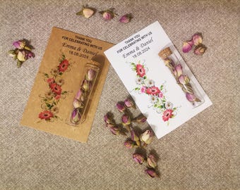 As wedding favor, personalized thank you card with rose tea in glass tube.