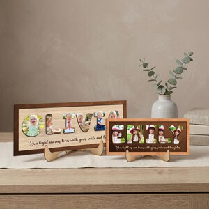 May include: Two wooden photo frames, one rectangular and one square, each displaying a name with photos inside the letters. The larger frame spells "OLIVER" and the smaller frame spells "EMILY". Both frames have the text "You light up our lives with your smile and laughter".