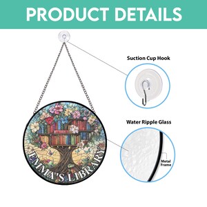 May include: A round, stained glass window hanging with a metal frame. The glass features a colorful mosaic design of a tree with books on its branches. The text "Emma's Library" is written on the bottom of the window.