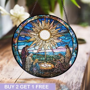 May include: A stained glass window depicting the Nativity scene with a bright star shining above. The scene includes Mary, Joseph, and the baby Jesus in a manger. The window is round and has a black metal frame.