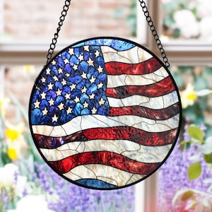 Könnte beinhalten: Ein Buntglasfenster mit einem runden Rahmen und einer Darstellung der amerikanischen Flagge. Die Flagge ist rot, weiß und blau mit einem blauen Sternenfeld.