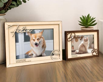 May include: Two wooden picture frames with pet photos. One frame is light-colored with the name "Felix" and a dog photo. The other is dark-colored with "Daisy" and a cat photo. Both frames have decorative elements.