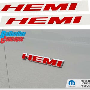 May include: Red "HEMI" decals and emblem. The decals are on a white background. The emblem is on a silver vehicle surface. The image also includes the "Reflective Concepts" logo and the Mopar official licensed product logo.