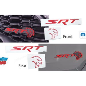 May include: Red SRT emblem decals for a car. The decals feature the SRT logo and a stylized animal head. The decals are shown on a gray car, one on the front grille and one on the rear bumper. The decals are officially licensed Mopar products.