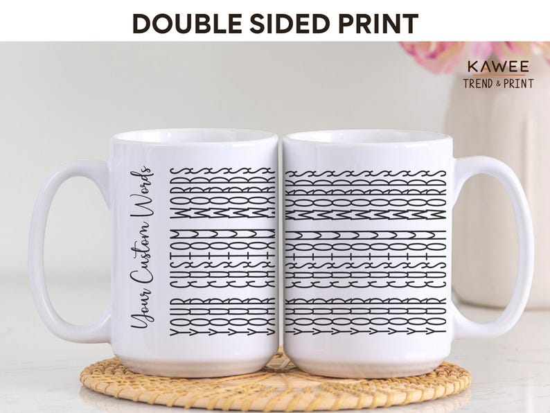 May include: Two white ceramic mugs with black designs. The mug on the left has the text "Your Custom Words" printed on it. The mug on the right has a pattern of black lines and shapes. The mugs are on a light brown surface.