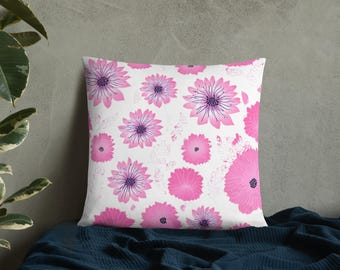 Almofada decorativa floral rosa com detalhes botânicos.