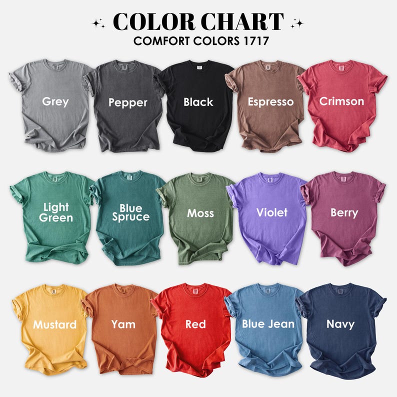 May include: A color chart displaying various Comfort Colors 1717 t-shirts. The shirts are arranged in rows, showcasing a range of colors including grey, black, red, and blue. Each shirt is labeled with its respective color name, such as "Grey," "Black," and "Red."