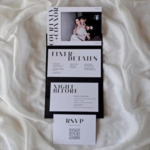 May include: A black and white wedding invitation suite with a photo of the couple on the top card. The text on the cards reads "Courtney + Connor", "Finer Details", "Night Before", and "RSVP".
