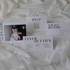 May include: Wedding invitation suite with a black and white color scheme. The invitation features a photo of the couple, the RSVP card has a QR code, and the details card includes information about the ceremony, dress code, and additional information.