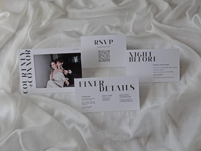 May include: Wedding invitation suite with a black and white color scheme. The invitation features a photo of the couple, the RSVP card has a QR code, and the details card includes information about the ceremony, dress code, and additional information.