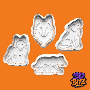 May include: Four white plastic wolf-shaped cookie cutters on an orange background. The cutters depict a wolf's head, a howling wolf, a standing wolf, and a walking wolf. The 3D BITZ logo is in the bottom right corner.