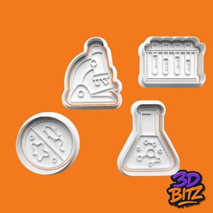 May include: Four white plastic cookie cutters in the shape of science-related objects. The shapes include a microscope, test tubes, a petri dish with a microbe design, and a flask with a molecular design. The background is orange.