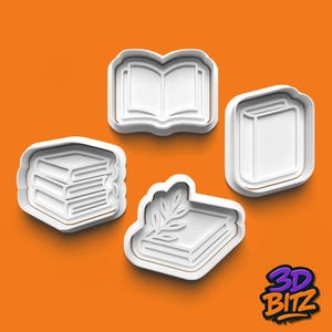 May include: Four white book-shaped cookie cutters on an orange background. The cutters include an open book, a closed book, a stack of books, and a book with a sprig of leaves. The 3D Bitz logo is in the bottom right corner.