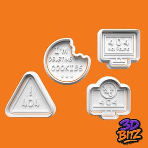May include: White plastic cookie cutters in various shapes, including a triangle with "404" and an exclamation mark, a bitten cookie with "I'M DELETING COOKIES", and two computer monitor designs with "404" and error messages. The background is orange.