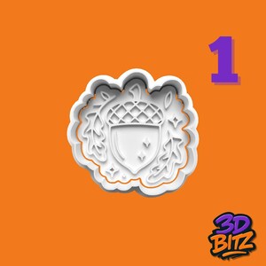 May include: White acorn-shaped cookie cutter with leaf and star details, set against an orange background. The number 1 is in purple in the upper right corner. The 3D BITZ logo is in the lower right corner.