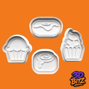 May include: Four white plastic cookie cutters shaped like a cupcake, a donut, a cinnamon roll, and a cupcake with frosting. They are set against an orange background. The 3D BITZ logo is in the bottom right corner.
