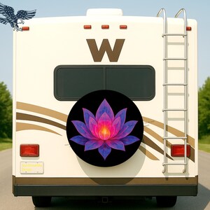 May include: A black spare tire cover featuring a vibrant, stylized lotus flower in shades of pink, purple, and blue. The cover is mounted on the back of a cream-colored RV, with a ladder and a large brown "W" visible.