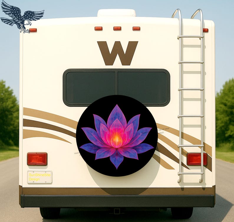 May include: A black spare tire cover featuring a vibrant, stylized lotus flower in shades of pink, purple, and blue. The cover is mounted on the back of a cream-colored RV, with a ladder and a large brown "W" visible.