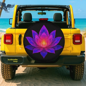 May include: A yellow Jeep with a black spare tire cover featuring a vibrant lotus flower design in shades of purple, pink, and yellow. The background shows a beach and ocean.