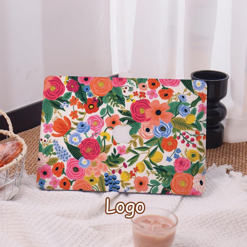 May include: A laptop case with a vibrant floral pattern featuring pink, orange, blue, and yellow flowers on a white background. The case has a cutout for the Apple logo. The word "Logo" is printed at the bottom.