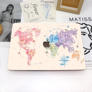 May include: A beige laptop skin featuring a colorful world map design. The map is illustrated with various landmarks, airplanes, and the text "WORLD MAP". The skin has a dark brown apple logo in the center.
