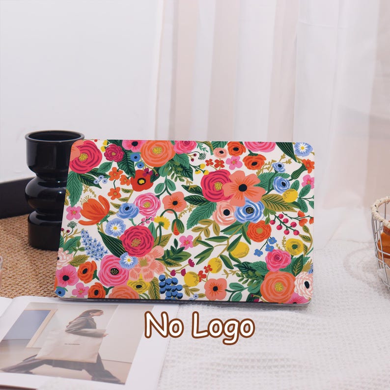 May include: A floral laptop case featuring a vibrant pattern of pink, orange, and blue flowers on a white background. The case has a rectangular shape and the text "No Logo" is printed on the bottom.