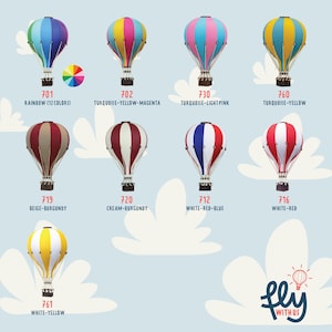 May include: A collection of colorful hot air balloon models. Each balloon features a unique design with various color combinations, including rainbow, turquoise, yellow, pink, red, and white. The image includes the text "fly with us."