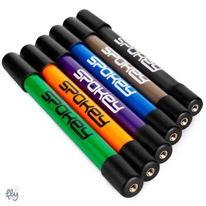 May include: A set of six Spokey mini bike pumps in different colours: green, orange, purple, blue, brown, and black. Each pump has a black cap and the Spokey logo printed on the side.