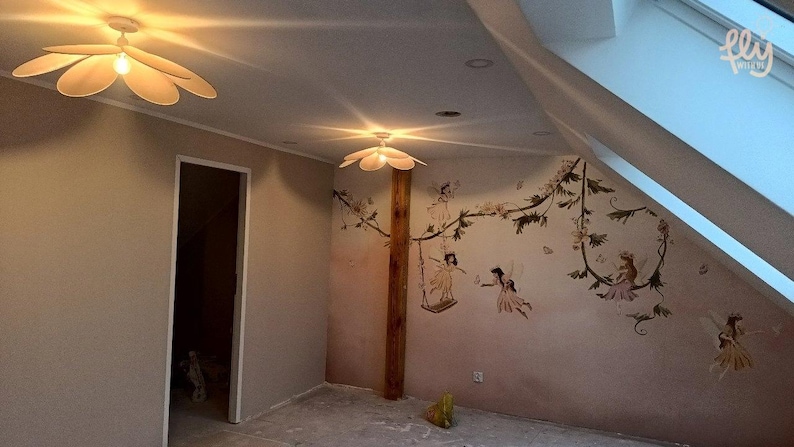 May include: A room with a whimsical fairy theme. Two flower-shaped ceiling lights illuminate the space. The walls feature a mural of fairies and floral vines. A door and a slanted window are also visible.