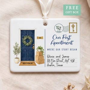 May include: A rectangular white ceramic ornament with a ribbon hanger featuring a blue door illustration, a wreath, potted plant, and stacked boxes. Text reads: Our First Apartment, WHERE OUR STORY BEGAN, Olivia and James, 88 Elm Street, Apt 4B, Austin, Texas.