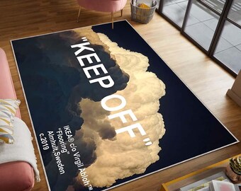 May include: A black and gold rug with a white cloud design and the text "KEEP OFF" in white. The text "IKEA® c/o Virgil Abloh™" is also printed on the rug, along with "Flooring", "Almhult, Sweden", and "c.2019".