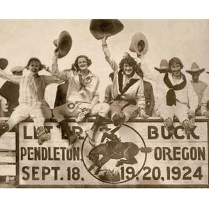 May include: Vintage sepia-toned photograph of a group of people sitting on a wooden fence, holding hats in the air. The sign reads "LET PENDLETON BUCK OREGON SEPT. 18. 19/20, 1924" with a rodeo illustration.